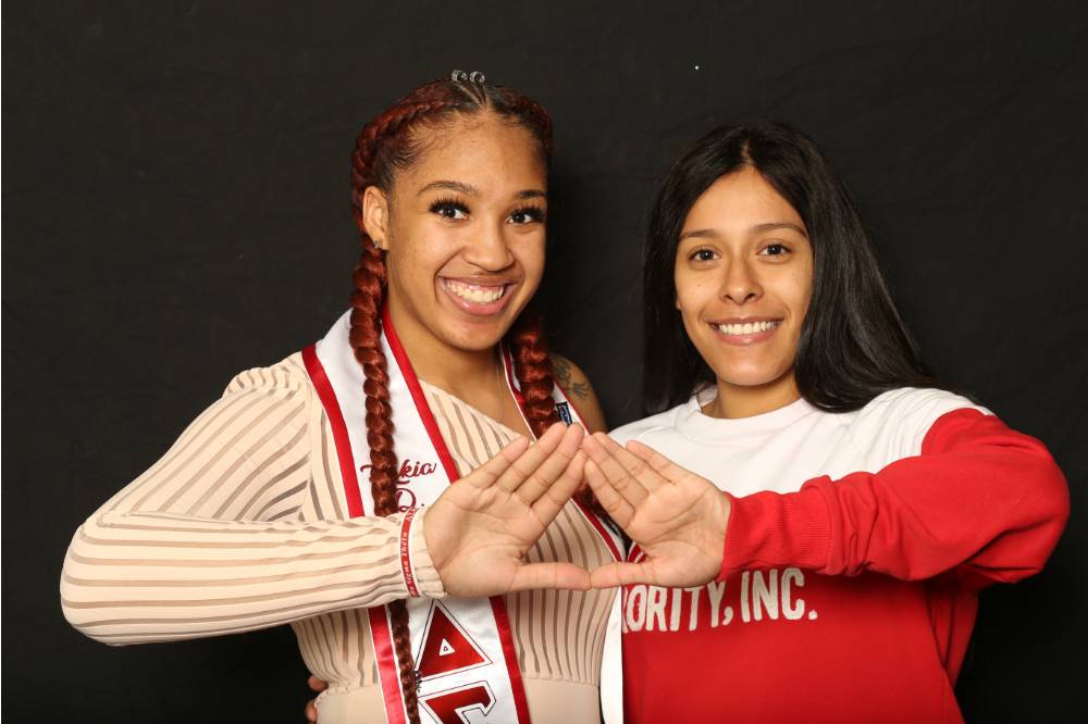 two students sorority sign